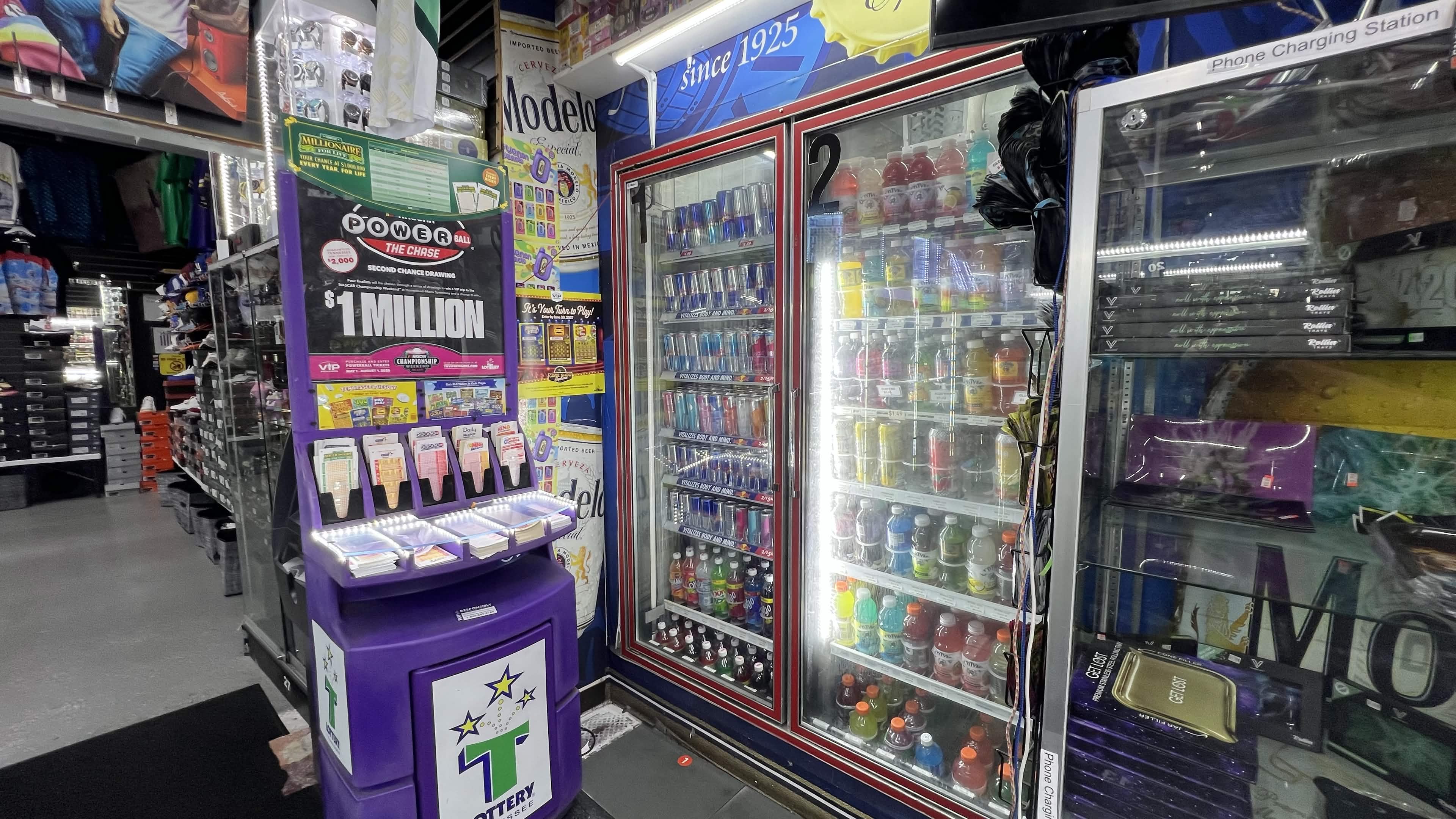 Tennessee Lottery Powerball display beside an energy-drink cooler inside Tobacco Brew & Chew